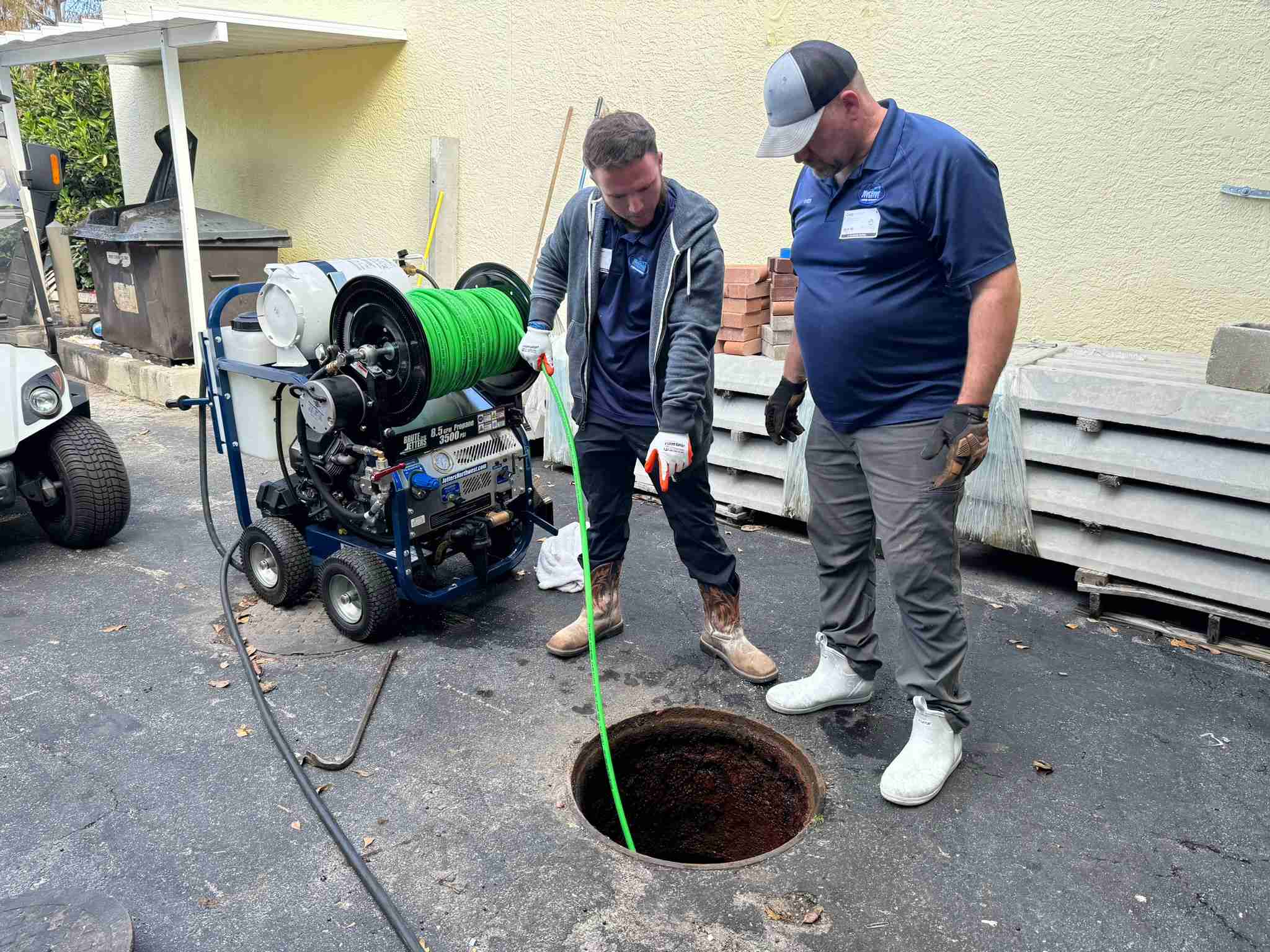 WC Plumbing technician jetting a commercial drain line
