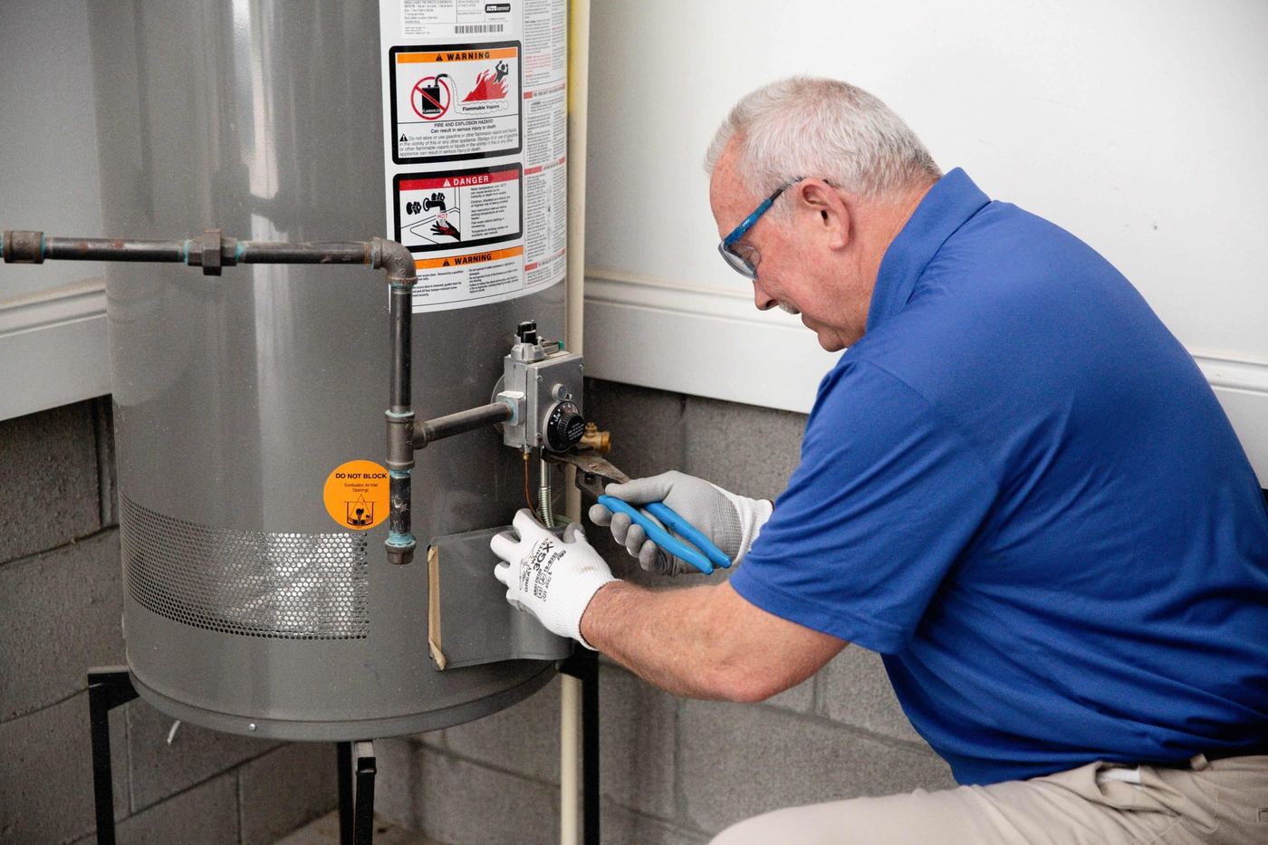 Technician servicing a water heater